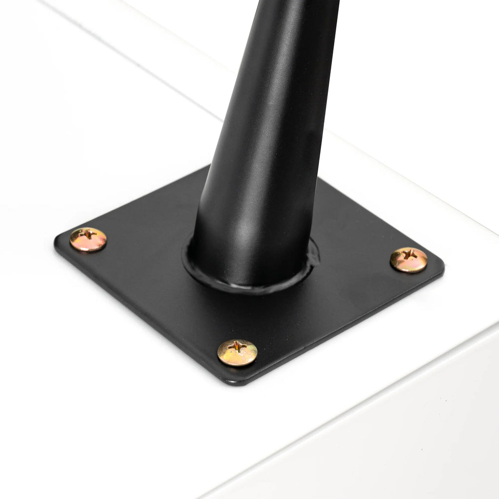 Close-up of a black steel leg base with screws attached to a white modern night stand.