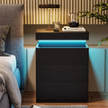 Modern black LED nightstand with blue ambient lighting next to a grey upholstered bed.