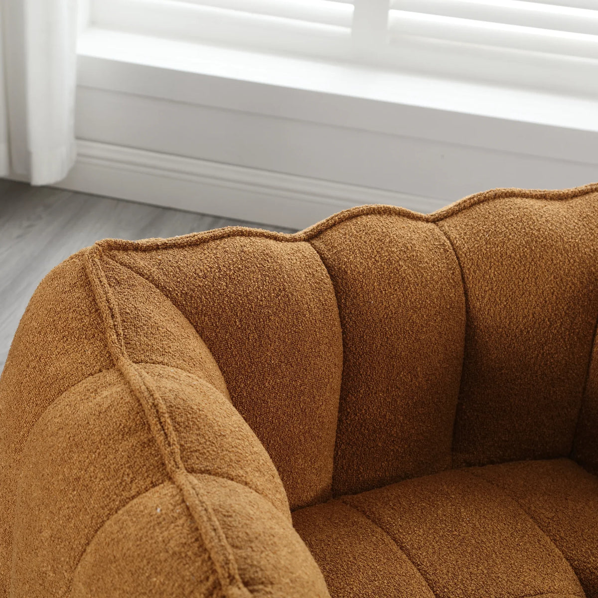Brown soft square bean bag chair with footstool by eprolo in a bright room.