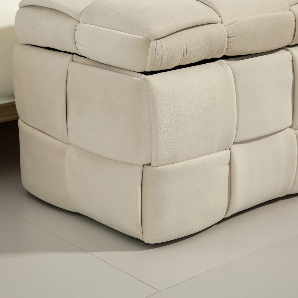 Beige cushioned fabric storage ottoman chair by eprolo with tufted design.