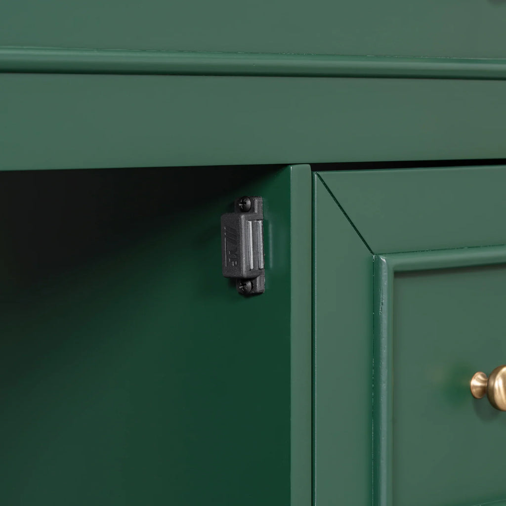Close-up of a black magnetic door catch on a green eprolo bathroom vanity cabinet.
