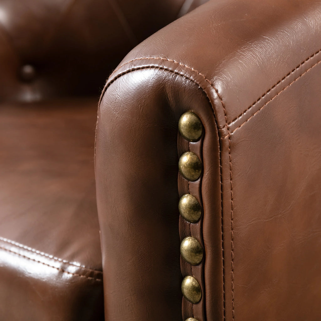 Close-up of brown PU leather tufted barrel chair with decorative brass nailhead trim by eprolo