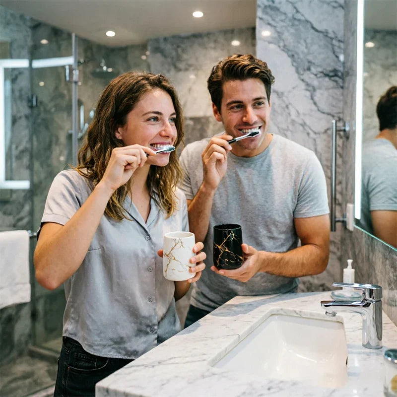 Couple smiling while brushing teeth with eprolo luxury ceramic marble tumblers in a bathroom.