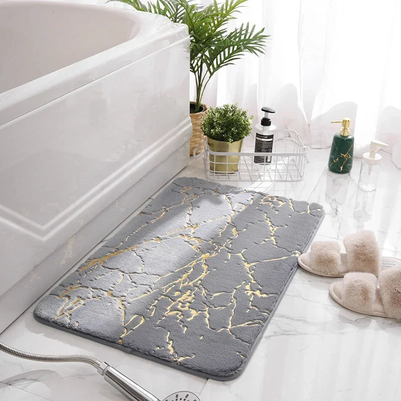 Grey eprolo non-slip imitation rabbit fur bathroom mat with gold marble veins next to a bathtub