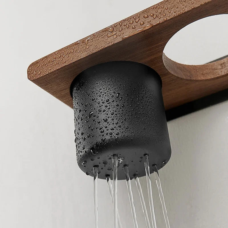 Black matte shower head with water droplets mounted on a wooden bathroom wall rack by eprolo