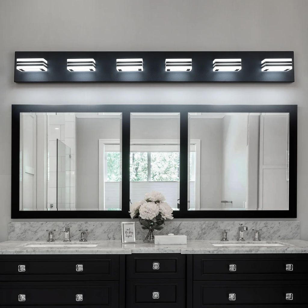 Modern eprolo black LED vanity lights installed over a large bathroom mirror and marble vanity.