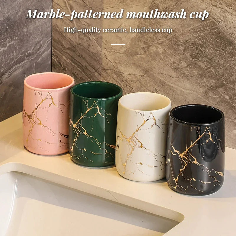 Set of four eprolo marble-patterned ceramic bathroom tumblers in pink, green, white, and black.