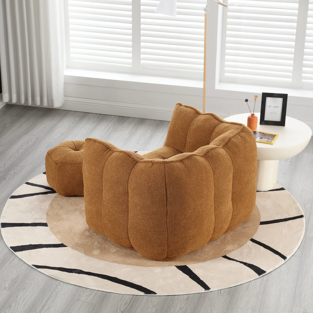 Brown soft square bean bag chair with matching footstool by eprolo on a patterned rug.
