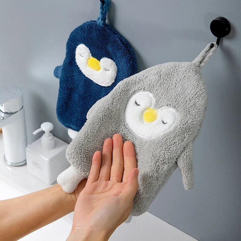 eprolo cute penguin coral velvet absorbent hand towels in blue and grey hanging in a bathroom.