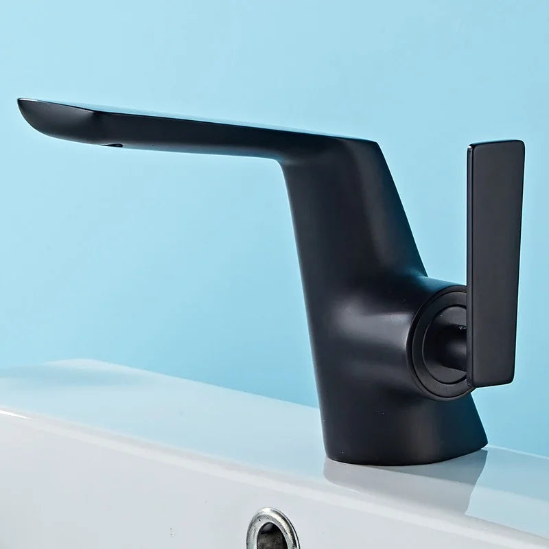 Modern matte black eprolo copper bathroom faucet on a white washbasin.