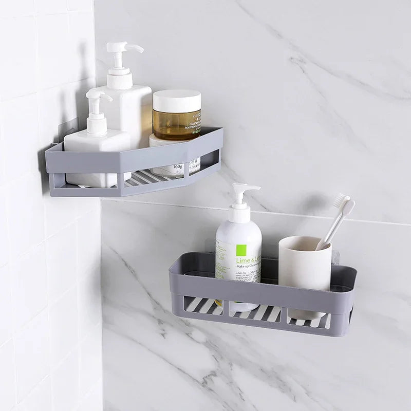 Two grey eprolo corner bathroom storage racks mounted on a marble wall with toiletries.