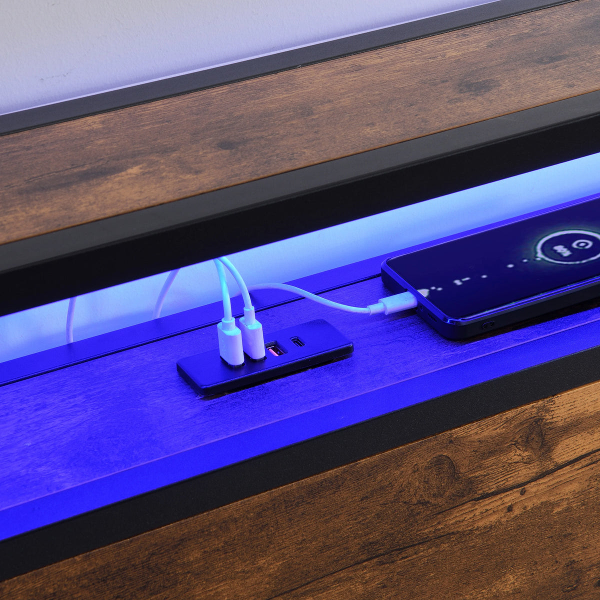 Smartphone charging via built-in USB ports on an eprolo LED platform bed headboard.