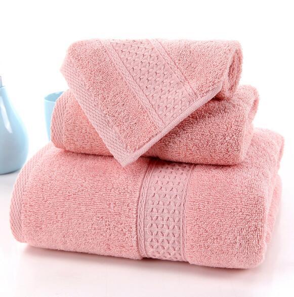 Set of three pink 100% cotton terry bath towels by eprolo with decorative woven borders.