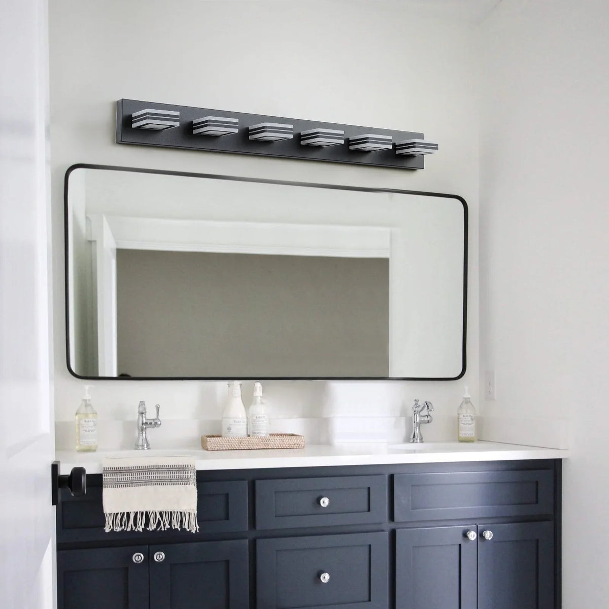 eprolo modern black 6-light LED bathroom vanity light above a mirror and dark blue cabinet