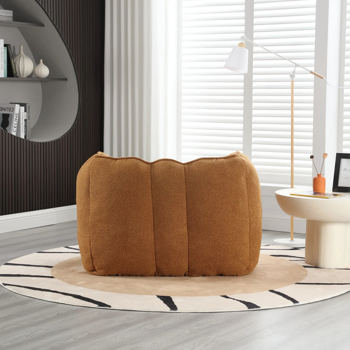 Brown soft square eprolo bean bag chair on a circular zebra print rug in a modern room