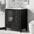 Black 30 inch eprolo bathroom vanity cabinet with white sink and three drawers.