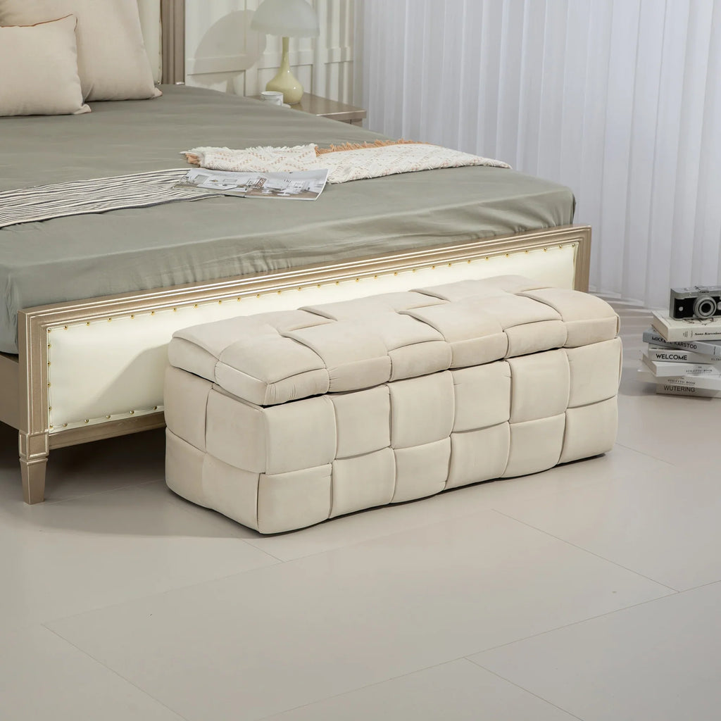 Beige eprolo cushioned fabric storage ottoman chair at the foot of a bed.