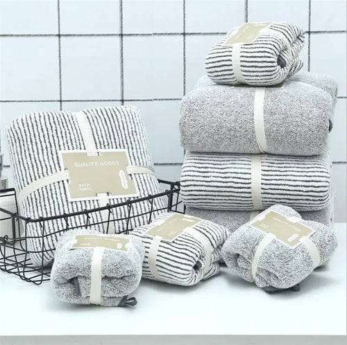 Stack of soft grey bamboo charcoal coral velvet bath towels by eprolo in a bathroom setting.