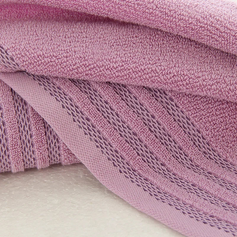 Close-up of a thick, purple eprolo cotton bath towel with a striped texture.