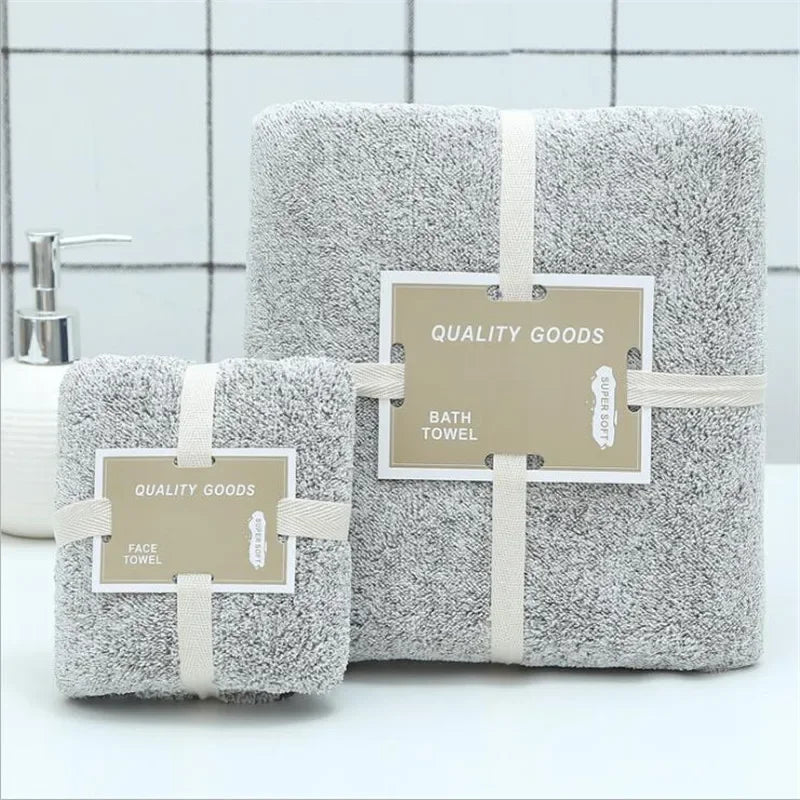 Set of gray eprolo bamboo charcoal coral velvet bath and face towels with packaging ribbons.